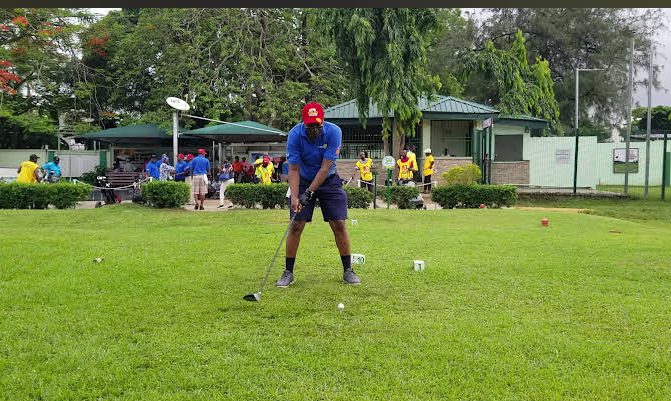 A golfer addresses the ball on the tee during a club competition